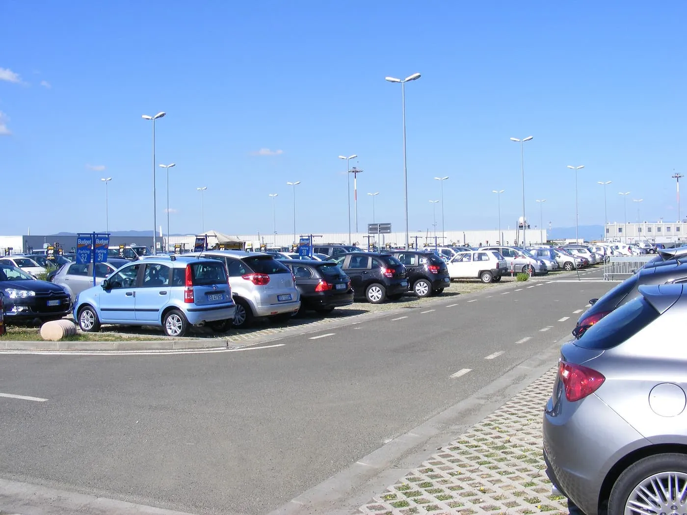 Rows of parked cars in a car park at Florence Airport