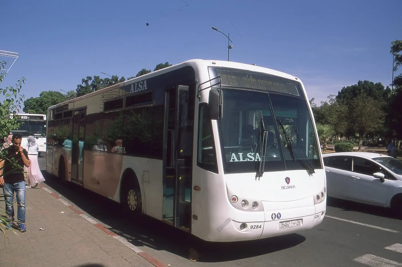 A white ALSA city bus at a kerb in Marrakech