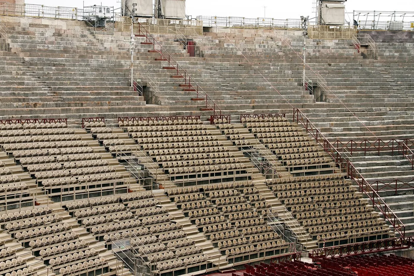 Rows of stone tiers inside the Verona Arena, with numbered seats set out on the lower steps