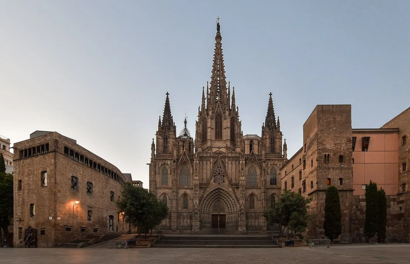 The Gothic façade of Barcelona Cathedral with its central spire, seen across the square in front