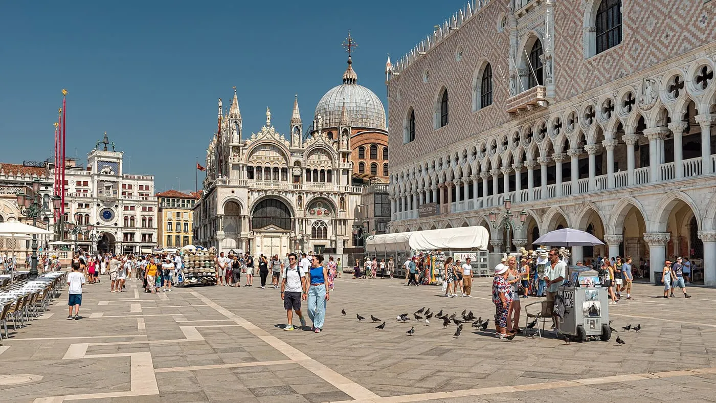 The front of St Mark's Basilica across the Square, with the Doge's Palace on the right