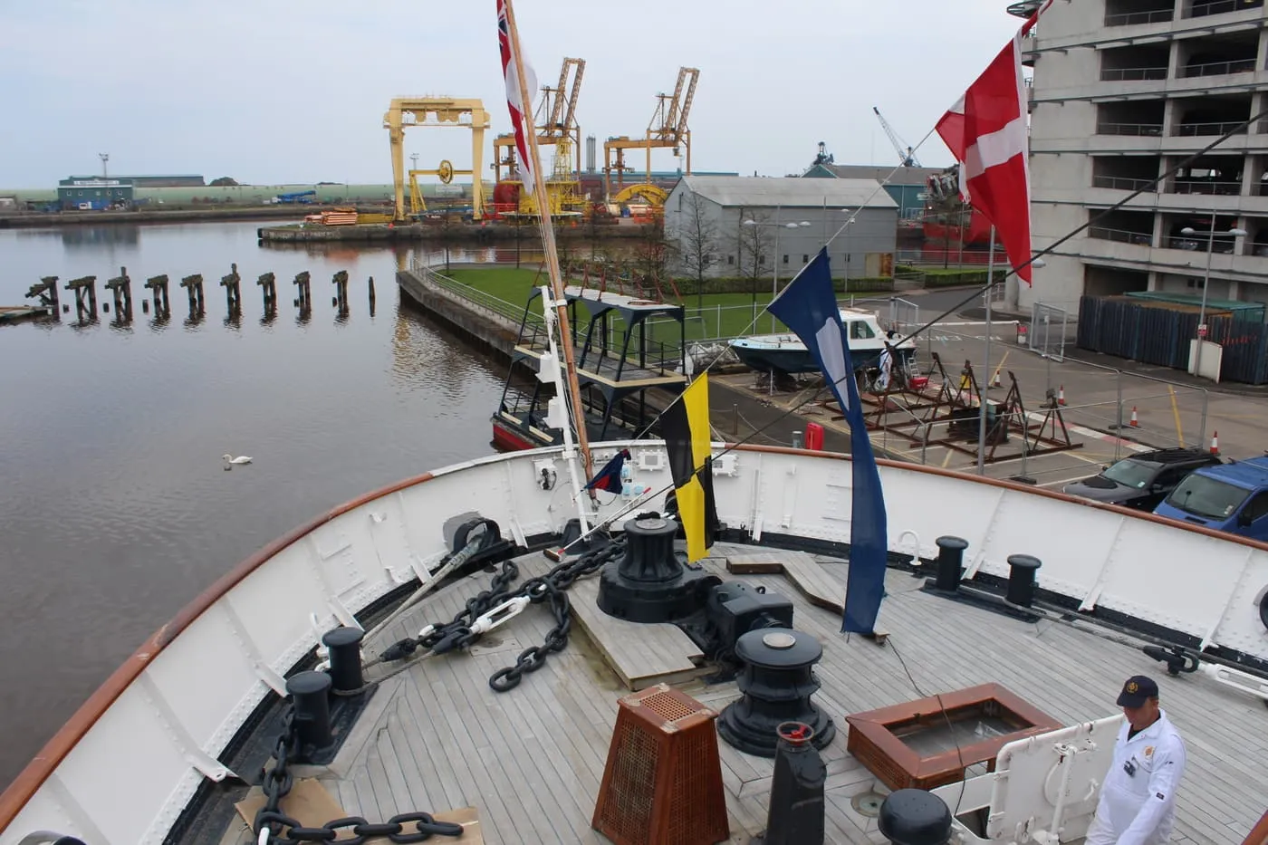 The teak fore deck of the Royal Yacht Britannia, with anchor chains and capstans, seen from the bridge