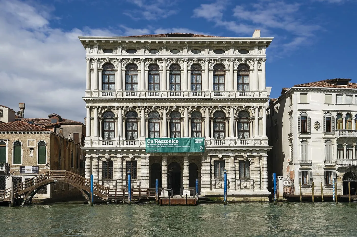 The white Baroque front of Ca' Rezzonico on the Grand Canal