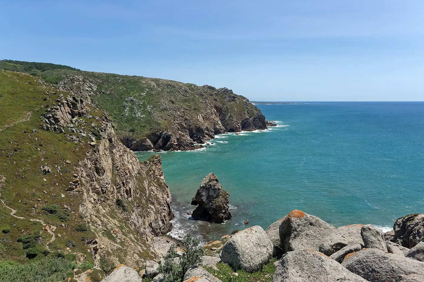 Green headlands and a sea stack at Cabo da Roca, with turquoise Atlantic water below