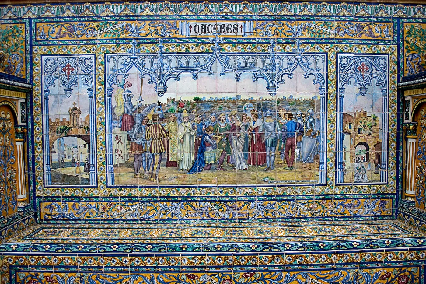 A tiled alcove bench with the name Cáceres across the top and a panel of figures in armour and robes