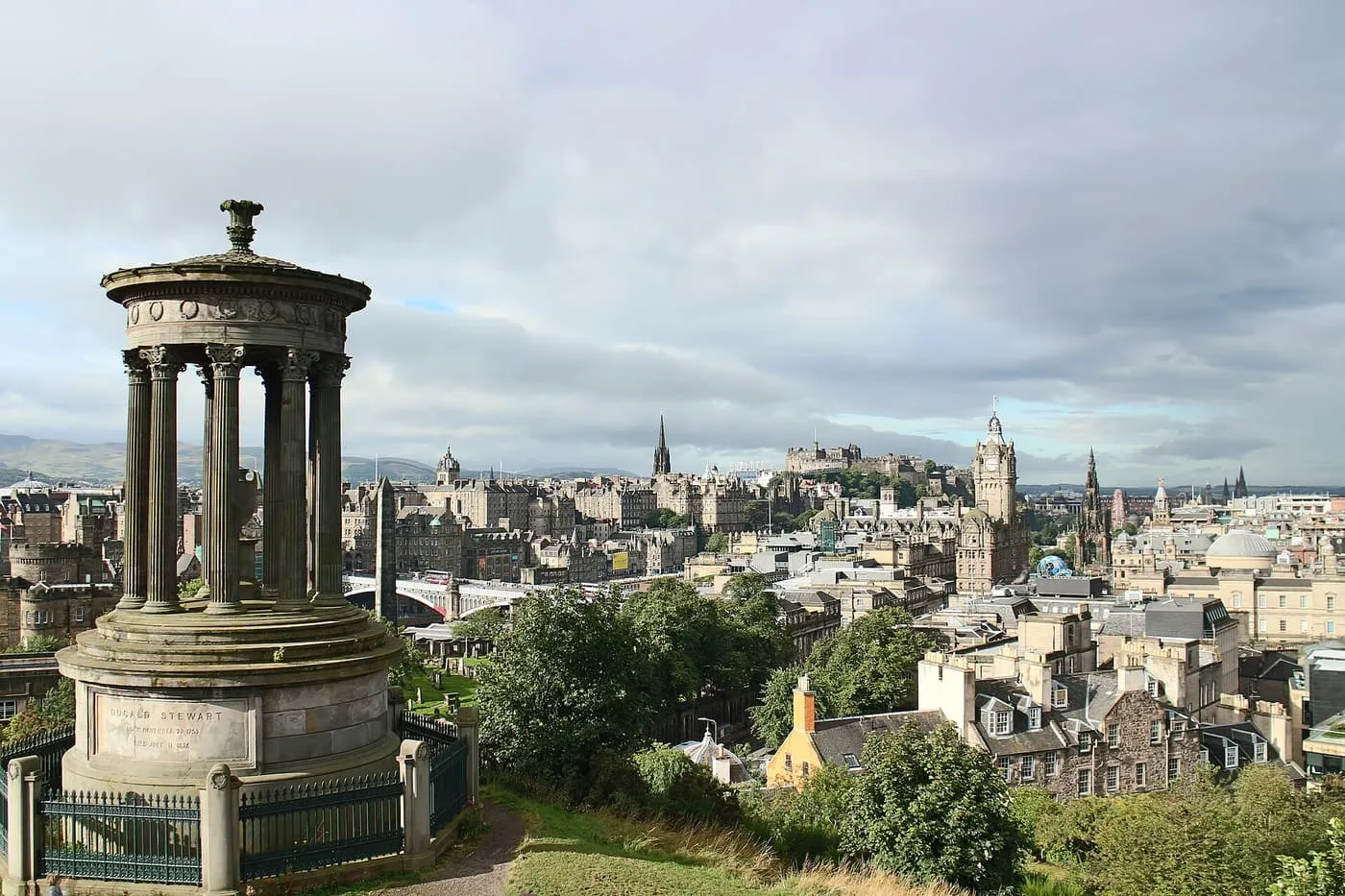 The round columned Dugald Stewart Monument on Calton Hill, with the Old Town and Princes Street skyline beyond