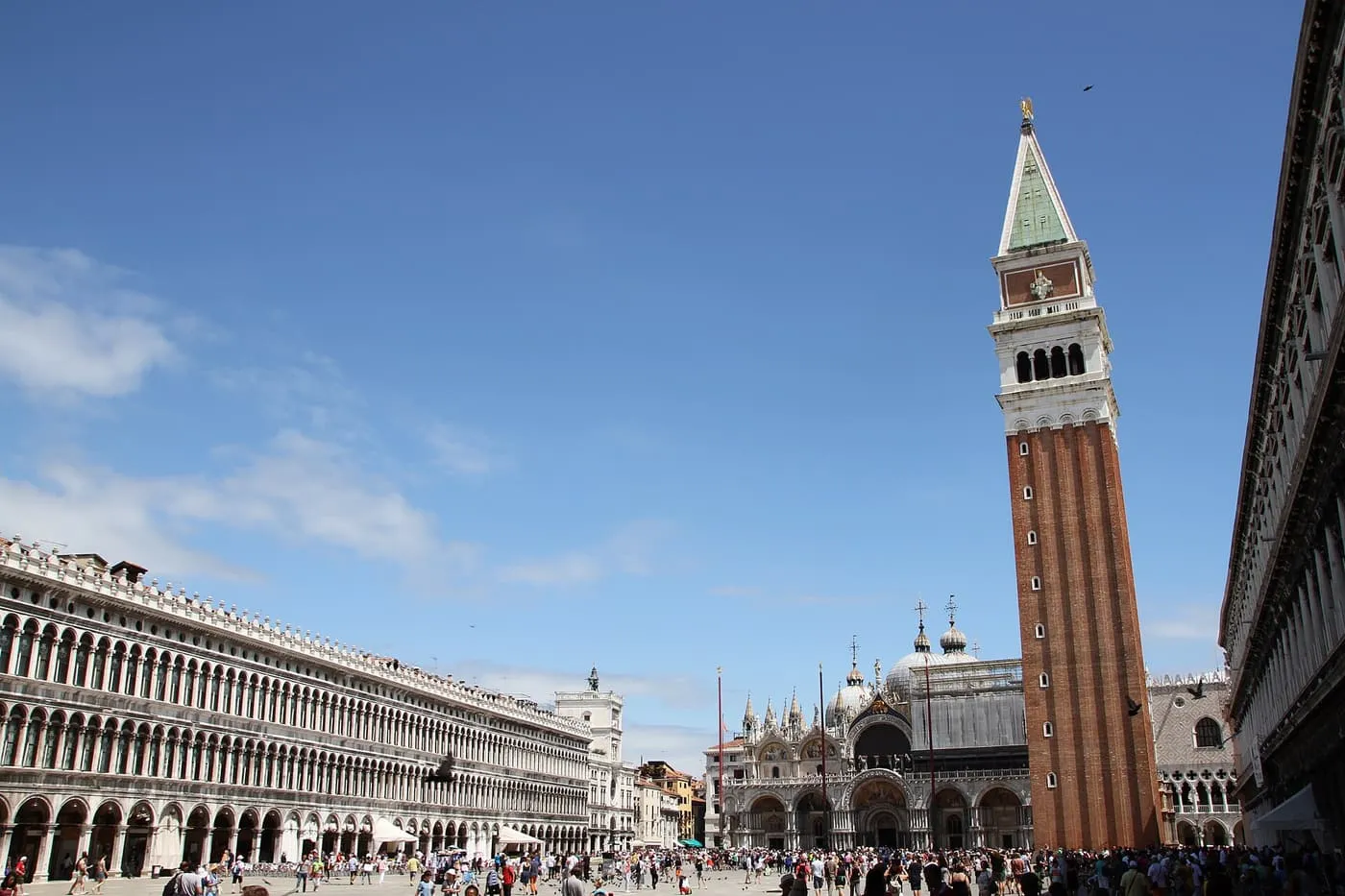 The brick Campanile beside the Basilica, with the arcades of the Procuratie on the left