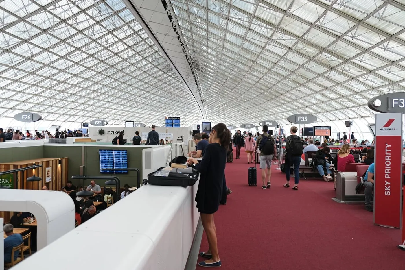 Departure gates under the glass and steel roof of Terminal 2F at Charles de Gaulle airport