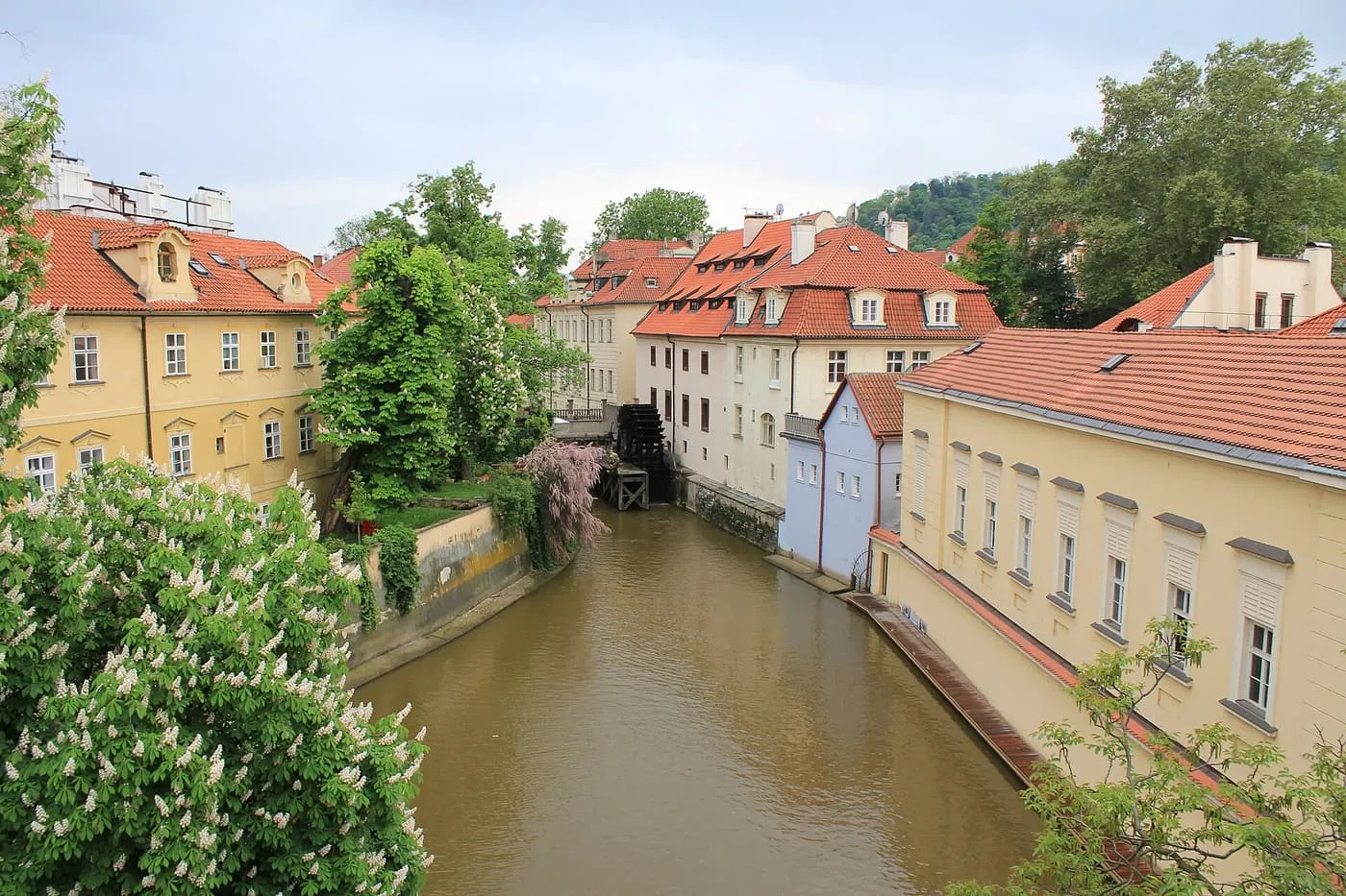 The Čertovka canal between Malá Strana and Kampa, with the mill wheel at the end of the channel between red-roofed houses