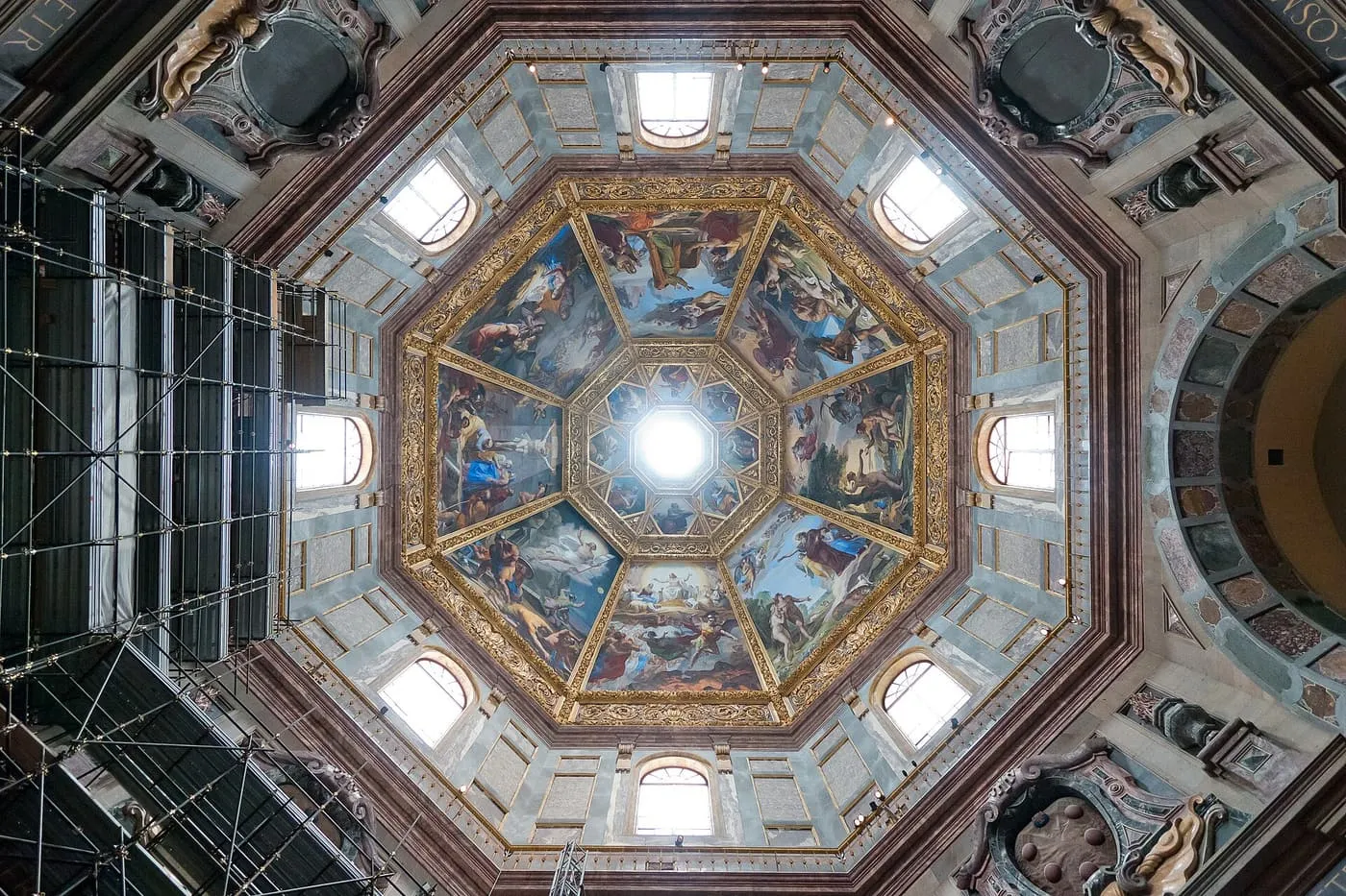The painted octagonal dome of the Chapel of the Princes, seen from below with scaffolding at the left