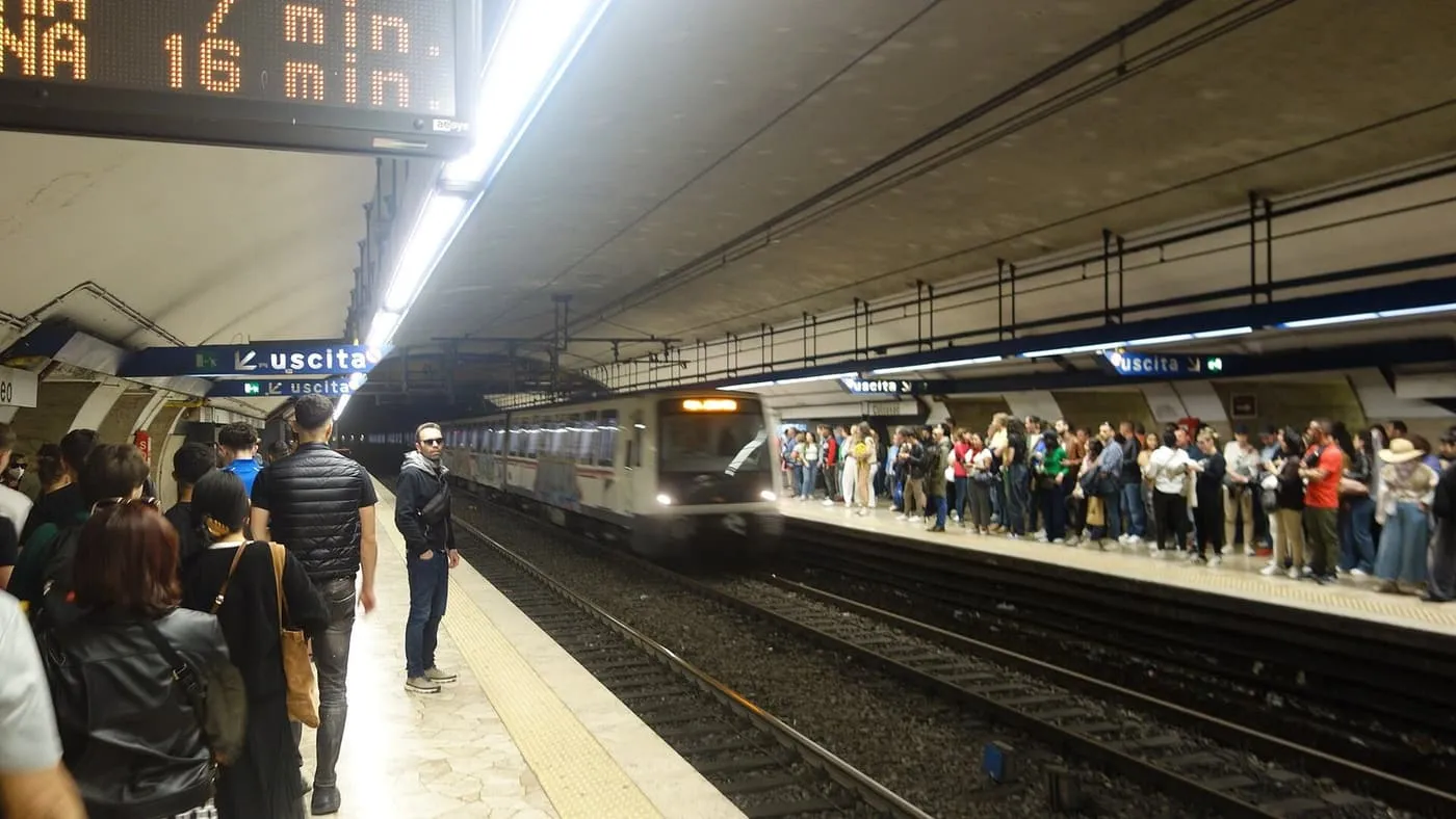 Passengers waiting on the Line B platform at Colosseo as a train pulls in