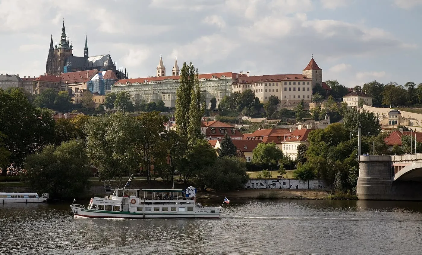 A river cruise boat on the Vltava below Prague Castle and St Vitus Cathedral