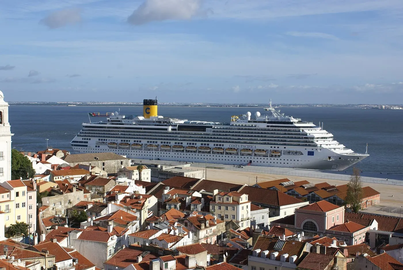 A cruise ship moored on the Tagus beyond the terracotta roofs of Alfama