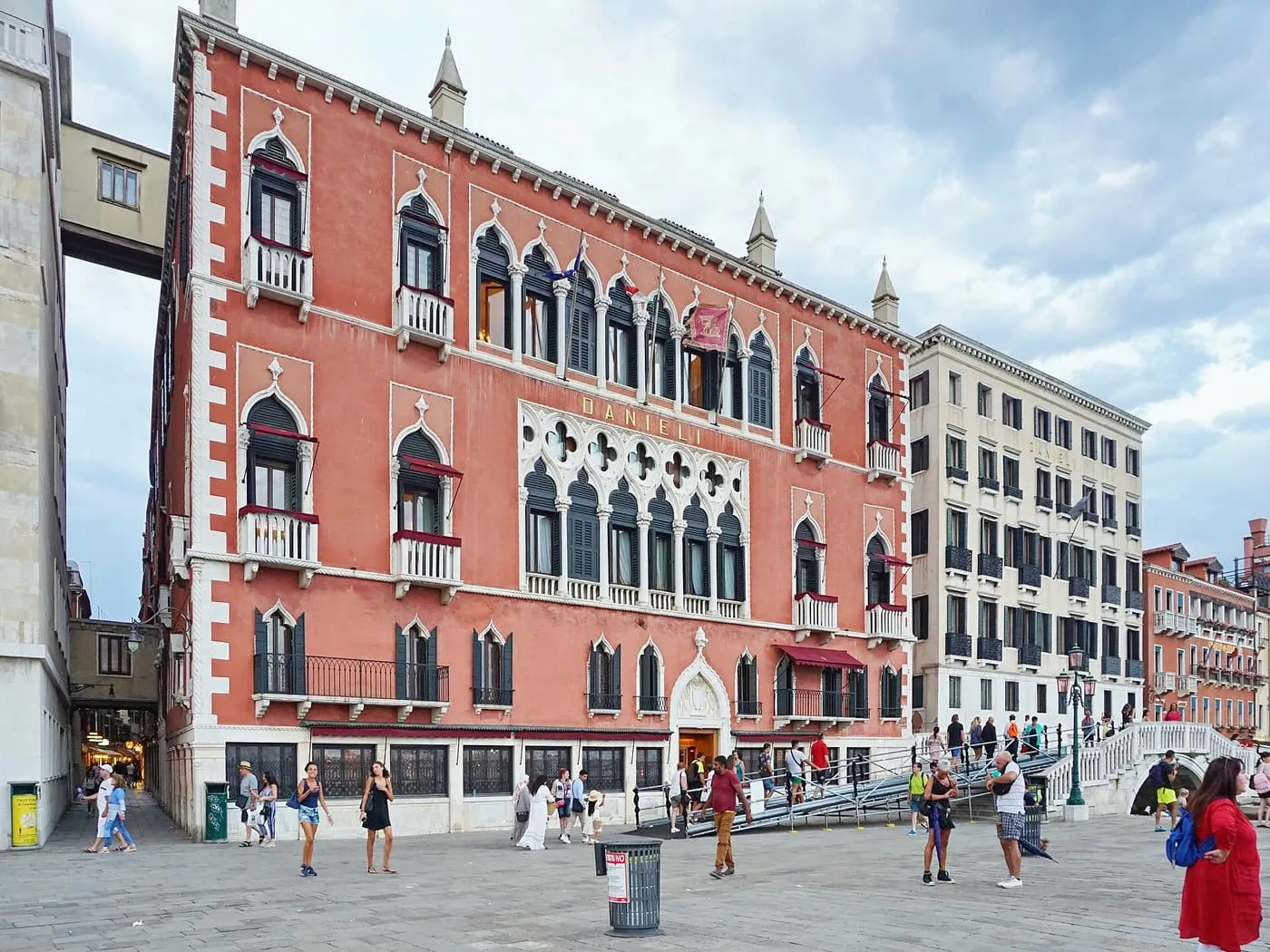 The pink Gothic façade of the Danieli on the Riva degli Schiavoni, with a white bridge to its right