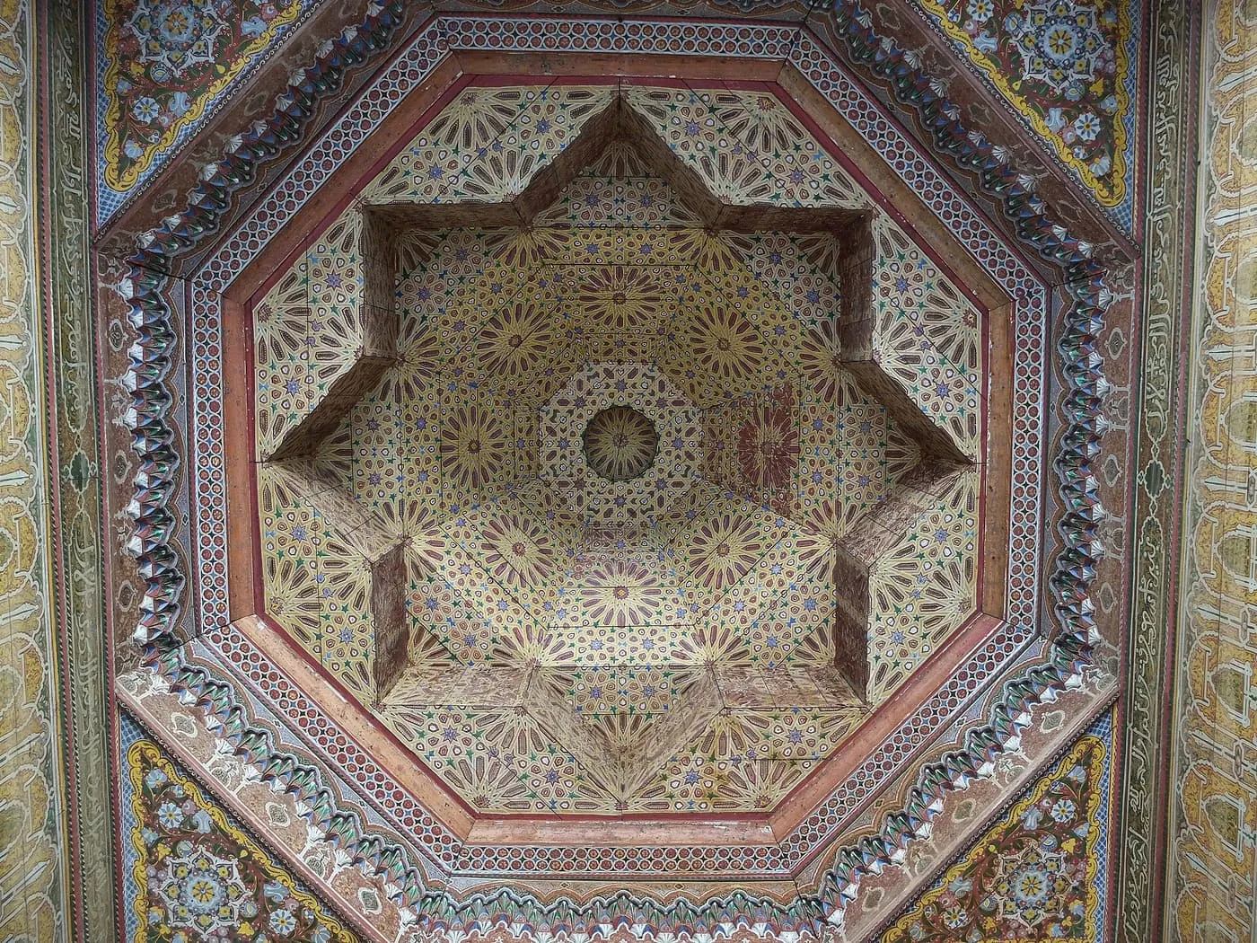 An octagonal painted wooden ceiling with a carved star at its centre in Dar El Bacha