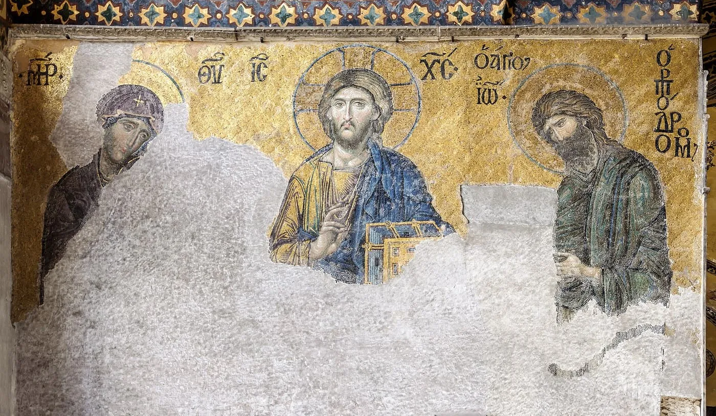 The Deësis mosaic: Christ in the centre with the Virgin and John the Baptist, in gold tesserae on a wall that is partly lost