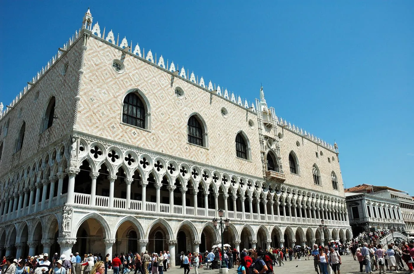 The corner of the Doge's Palace, with pink and white lozenge walls above two tiers of arcades