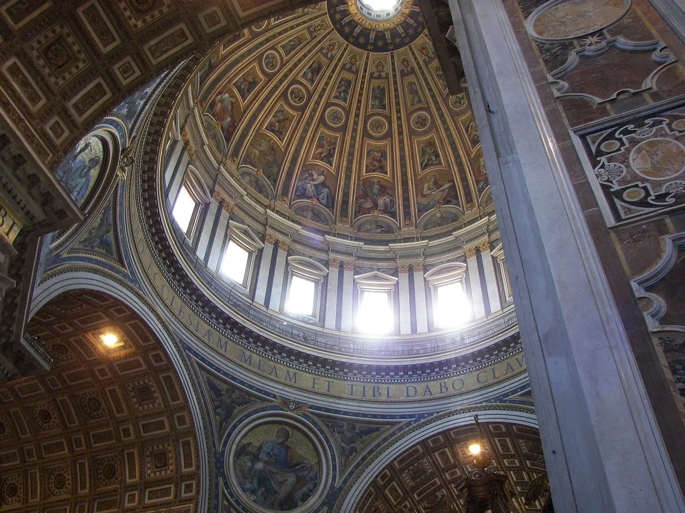 The inside of the dome, with mosaic panels of saints between the ribs and daylight through the windows below