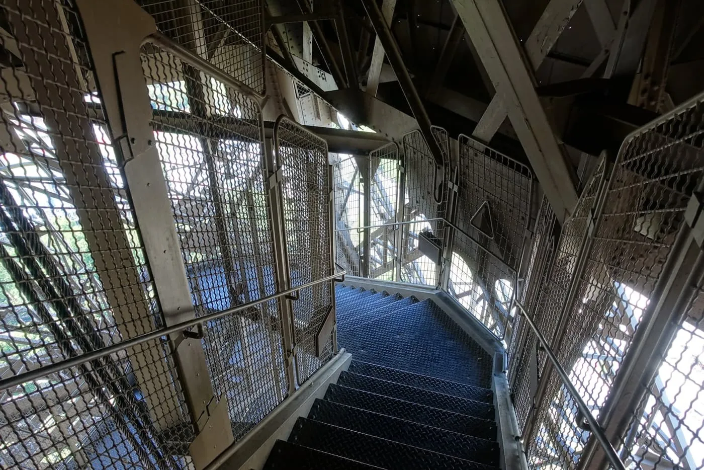Steel steps and mesh railings of the stairway to the Eiffel Tower's first floor