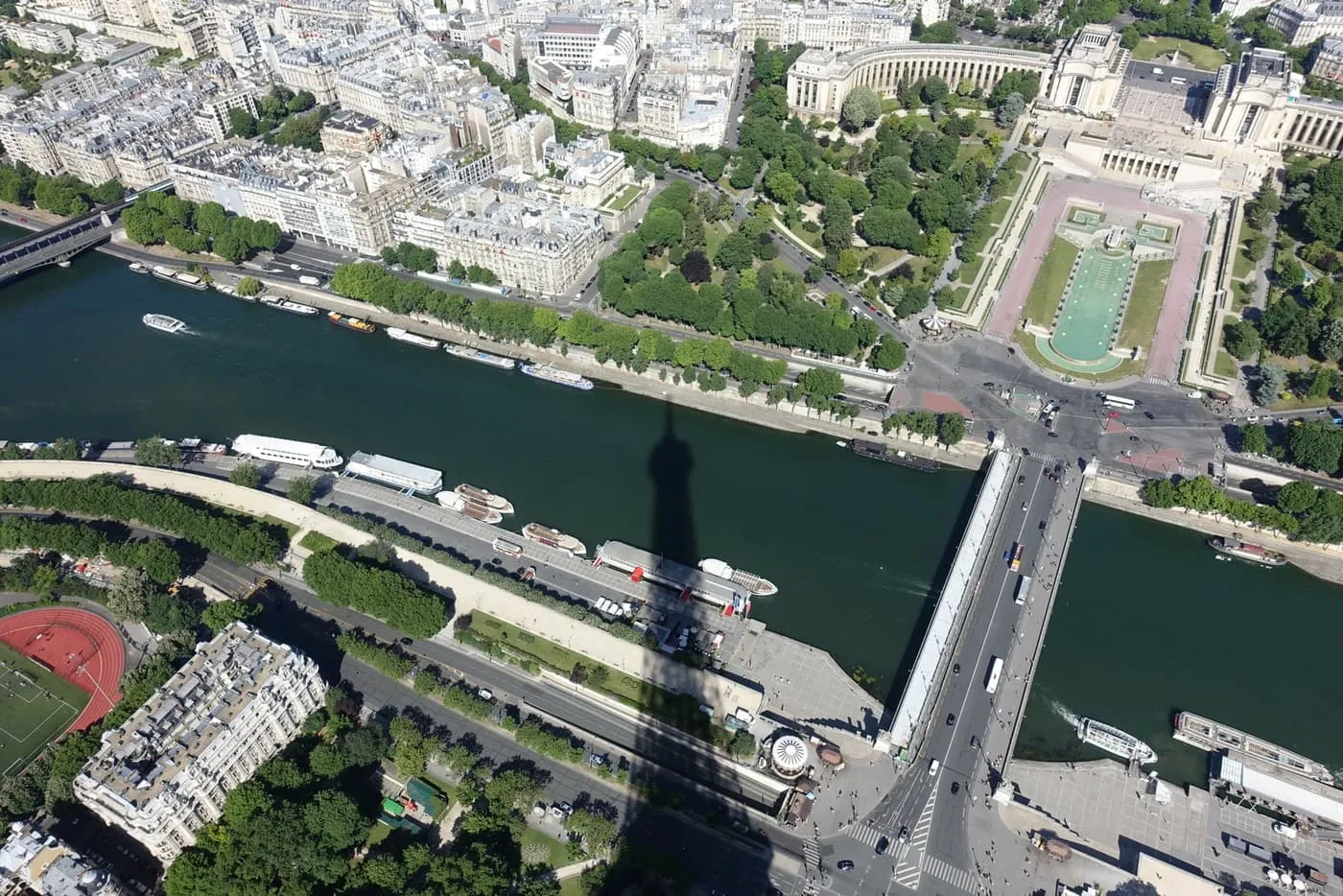 Looking down from the summit on the Seine, the Pont d'Iéna and the Trocadéro gardens, with the tower's shadow across the river