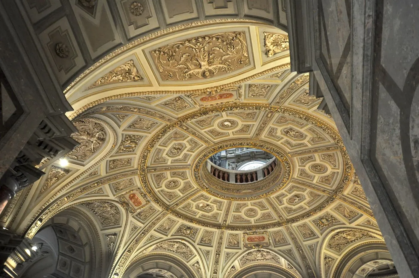 The coffered, gilded ceiling of the entrance hall, with a round opening to the floor above