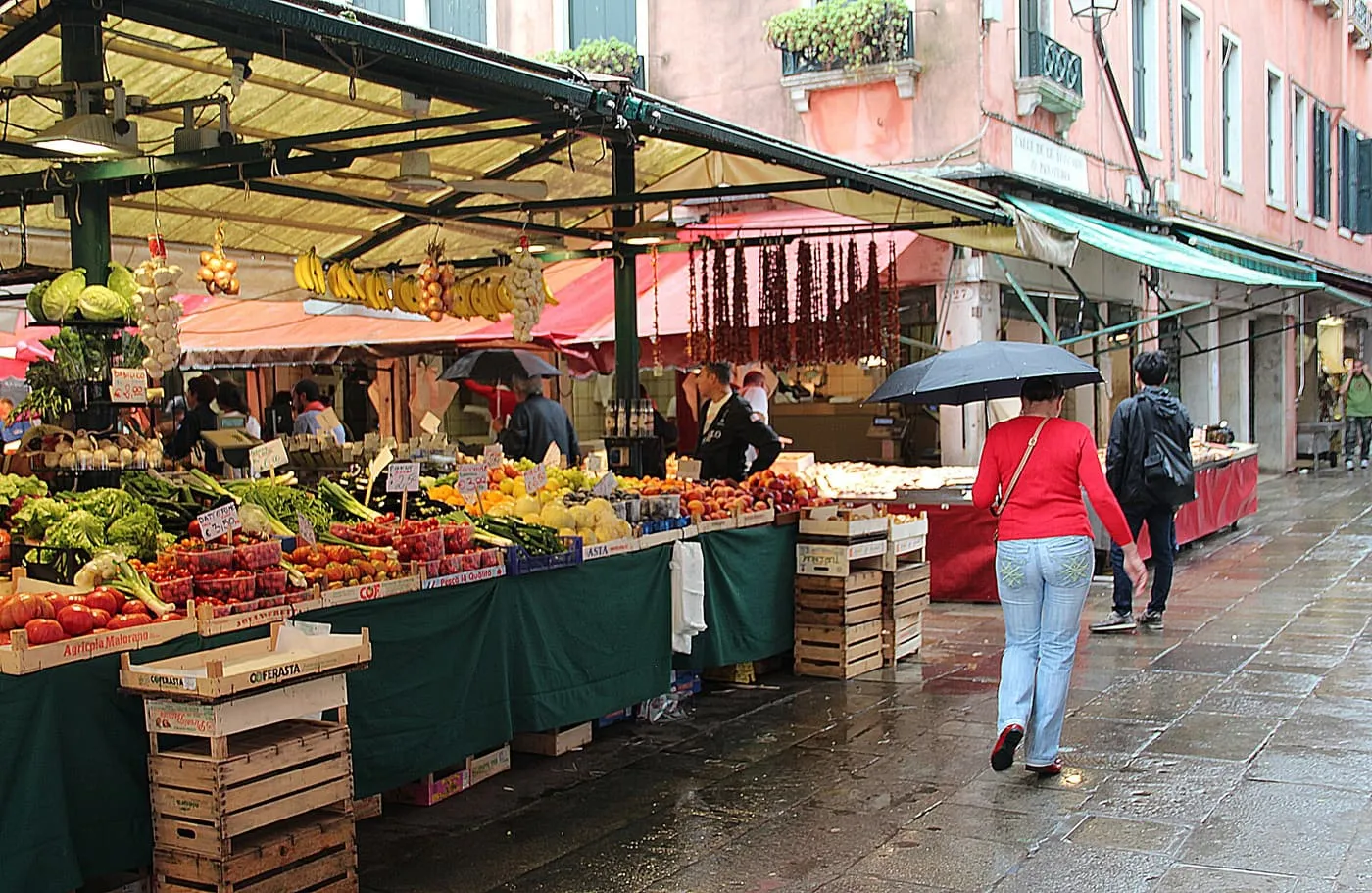 Fruit and vegetable stalls under awnings in the Erberia