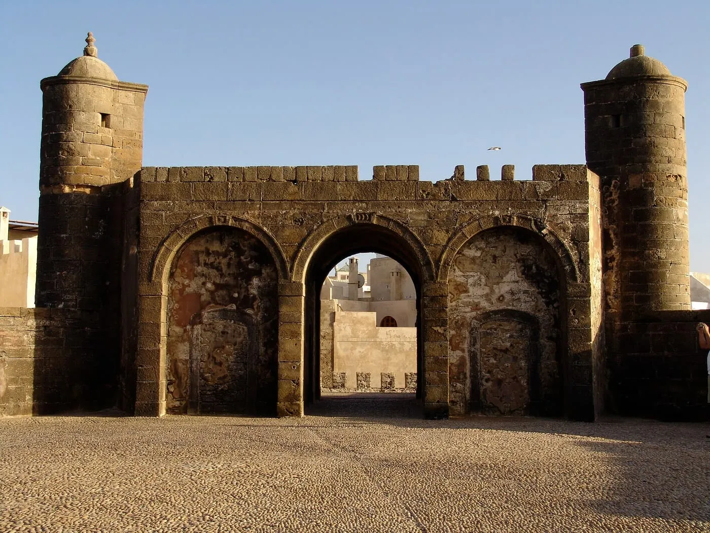 A stone gateway with three arches between two round corner towers on Essaouira's Skala de la Ville