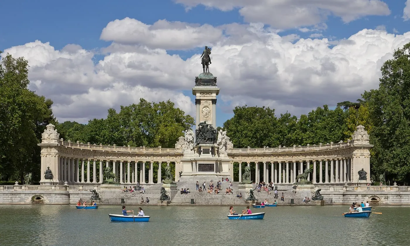 The Monument to Alfonso XII on the far side of the Estanque Grande in the Retiro, with its curved colonnade, equestrian statue and rowing boats on the water