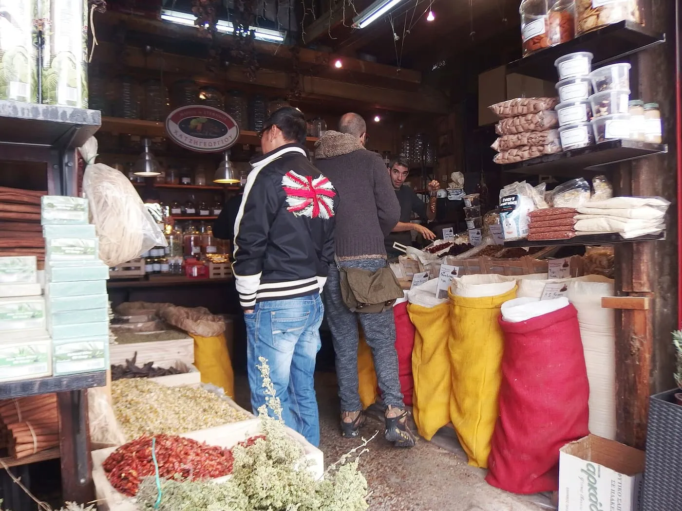 A spice and dried-herb shop on Evripidou Street, with bulk sacks of spices in red and yellow, boxes of dried chillies and herbs, and shelves of jars behind the counter