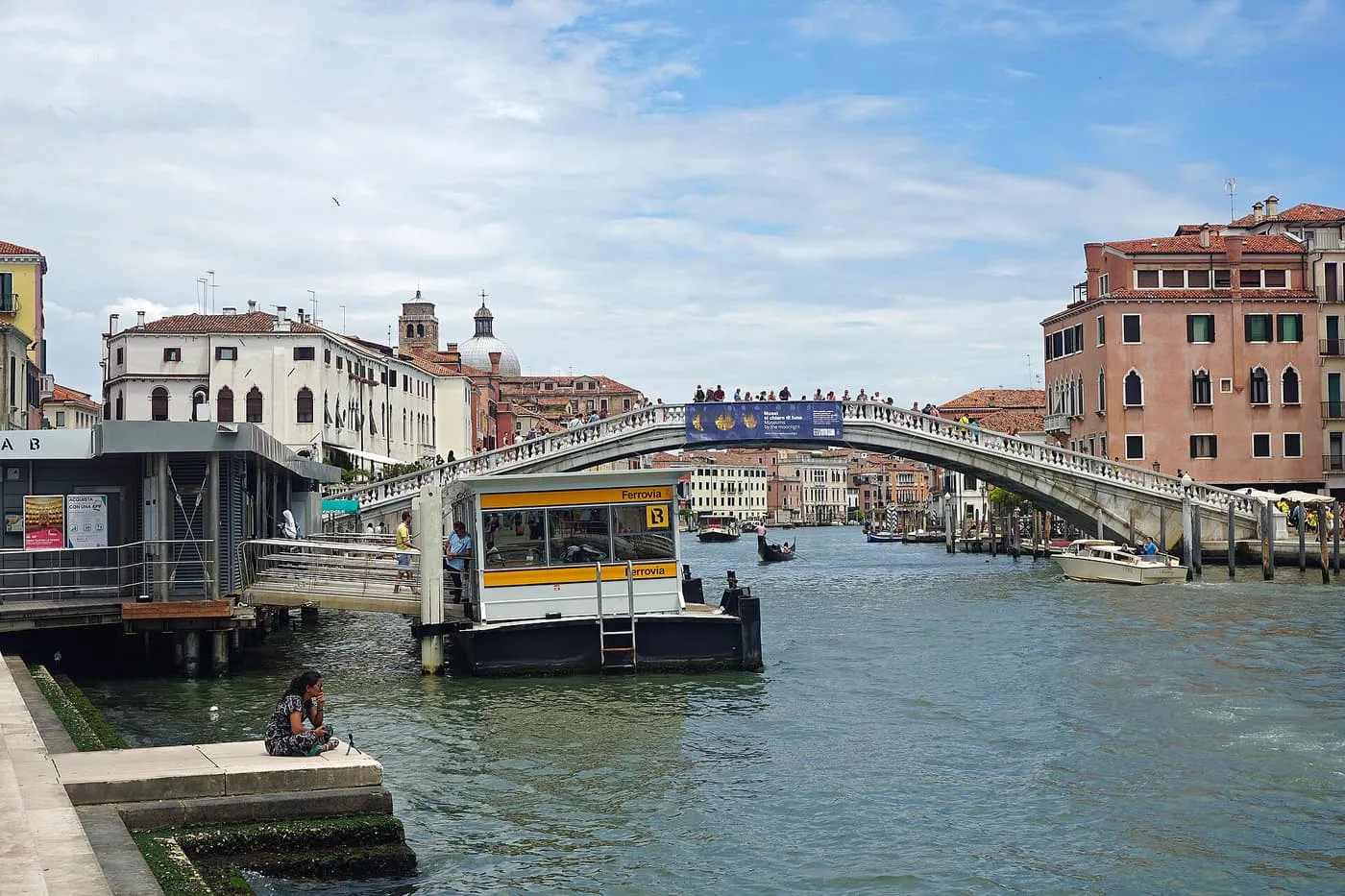 The Ferrovia vaporetto stop on the Grand Canal, with the Ponte degli Scalzi crossing the water behind it