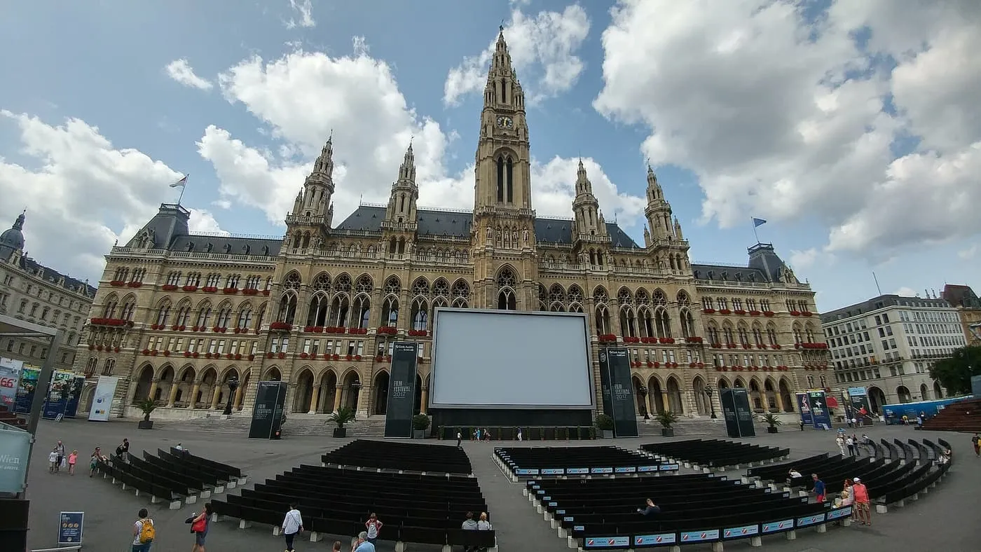A large screen and rows of benches set up in front of the City Hall on Rathausplatz for the Film Festival