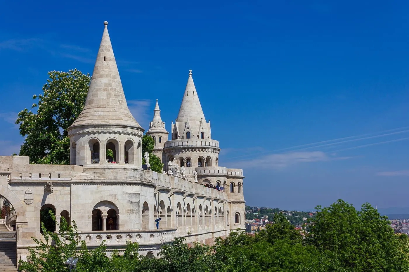 The white stone cone-roofed towers and arcades of Fisherman's Bastion against a blue sky