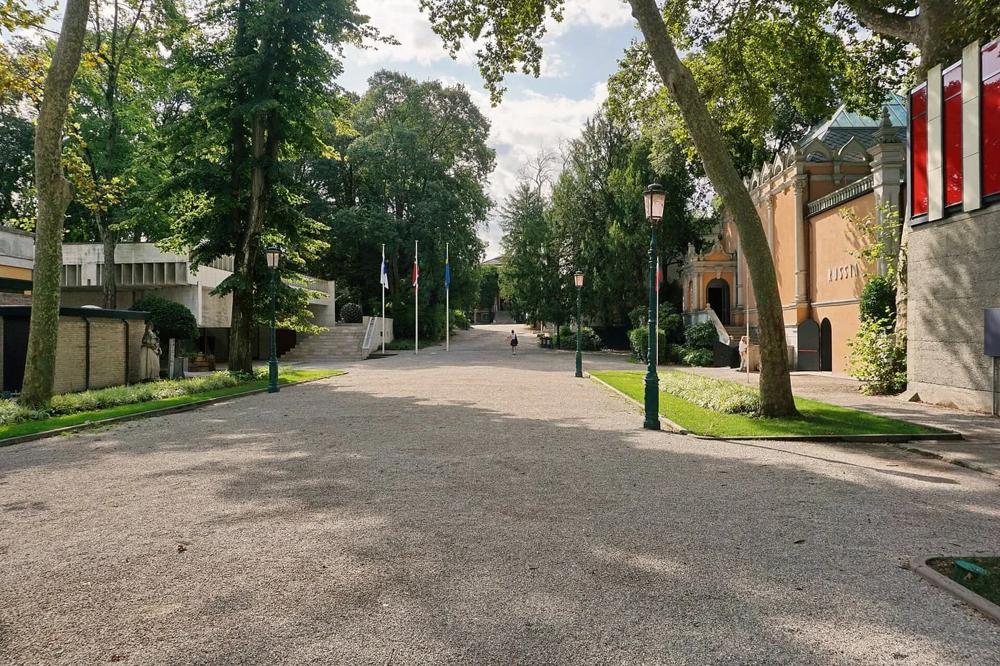 A gravel avenue lined with trees in the Giardini