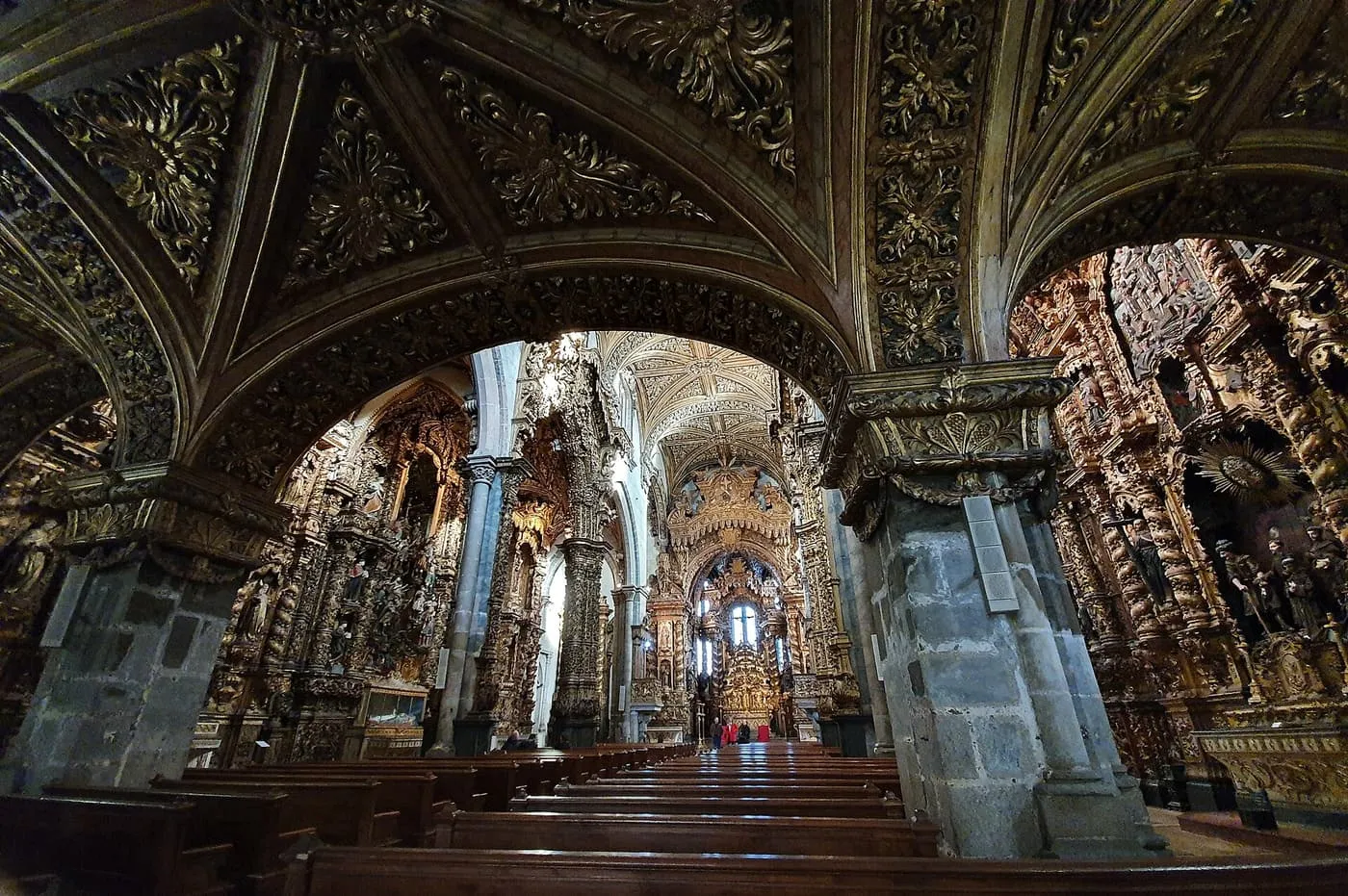 The nave of the Igreja de São Francisco, with gilded carving covering the vaults, columns and side altars