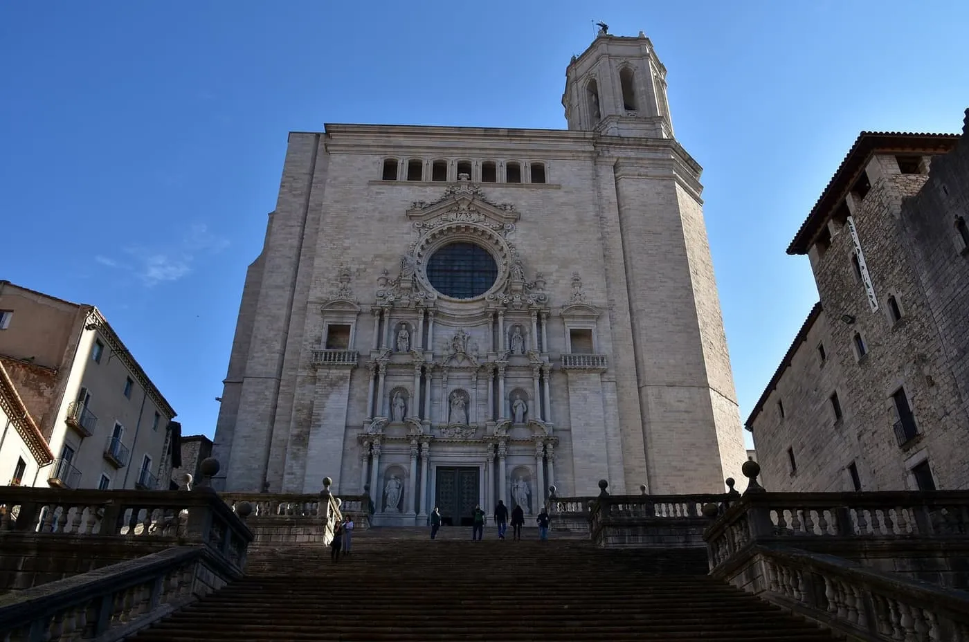 The broad Baroque stairway climbing to the west front of Girona Cathedral, with its rose window and bell tower