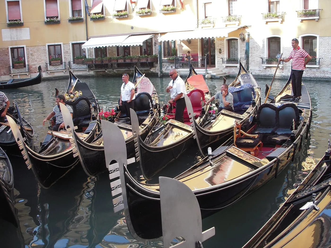 Gondoliers beside a row of moored gondolas in the Bacino Orseolo