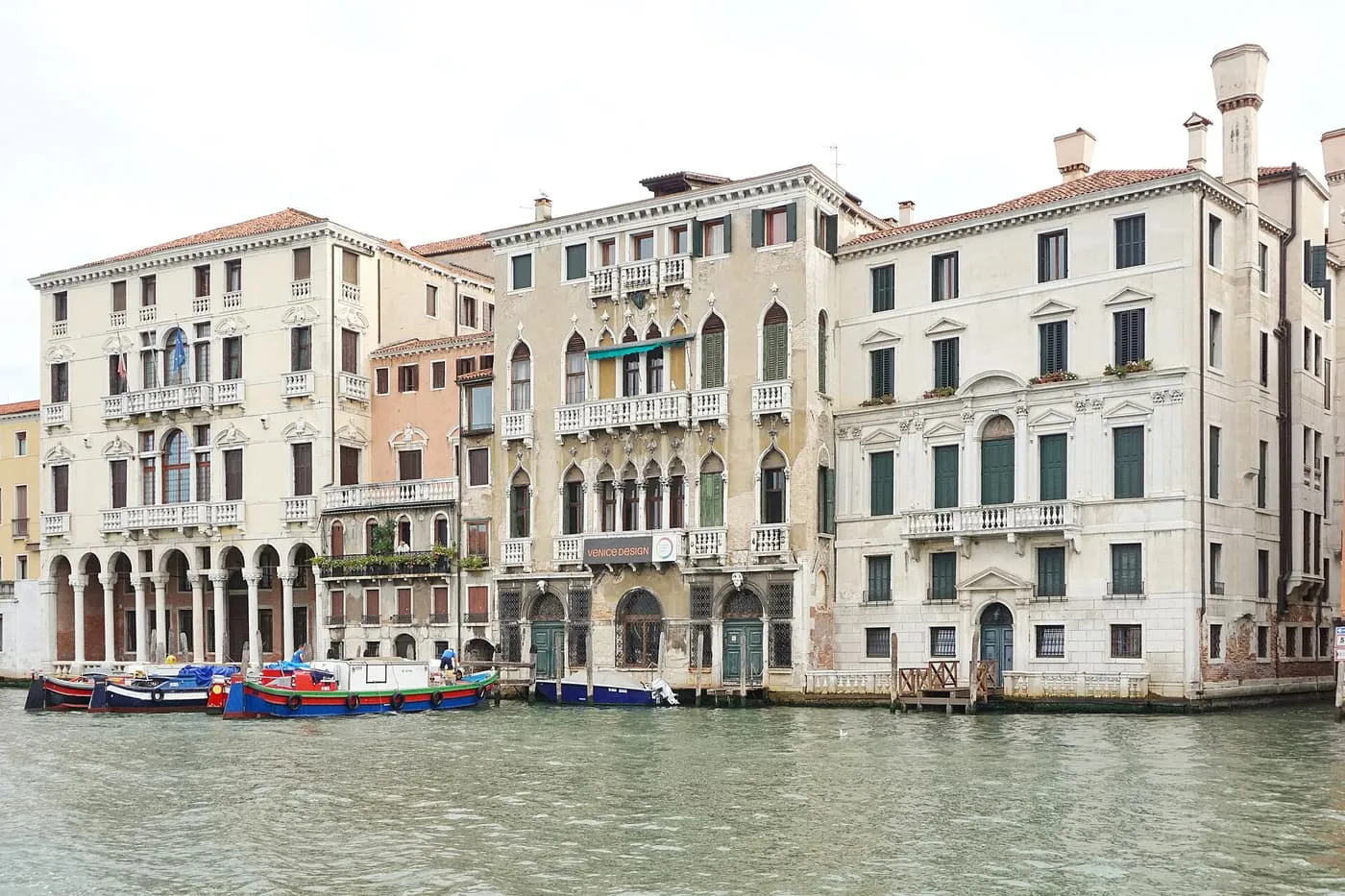 Three palaces on the Grand Canal in Cannaregio, with a green barge moored at their water gates