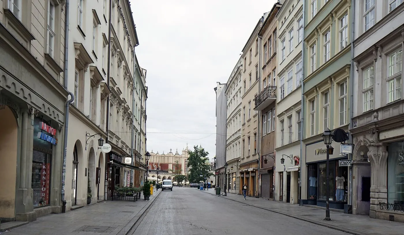 Grodzka Street, a long cobbled street of tall townhouses looking north, with almost no one on it