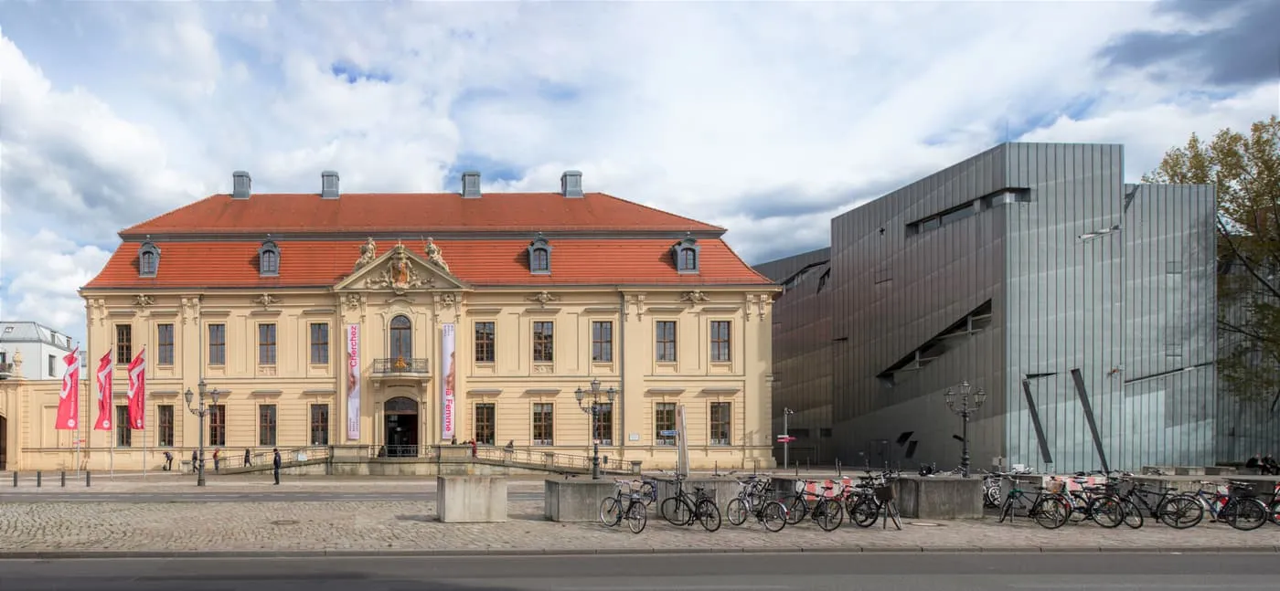 The Jewish Museum's baroque building with a red roof beside the zinc-clad, angular Libeskind Building