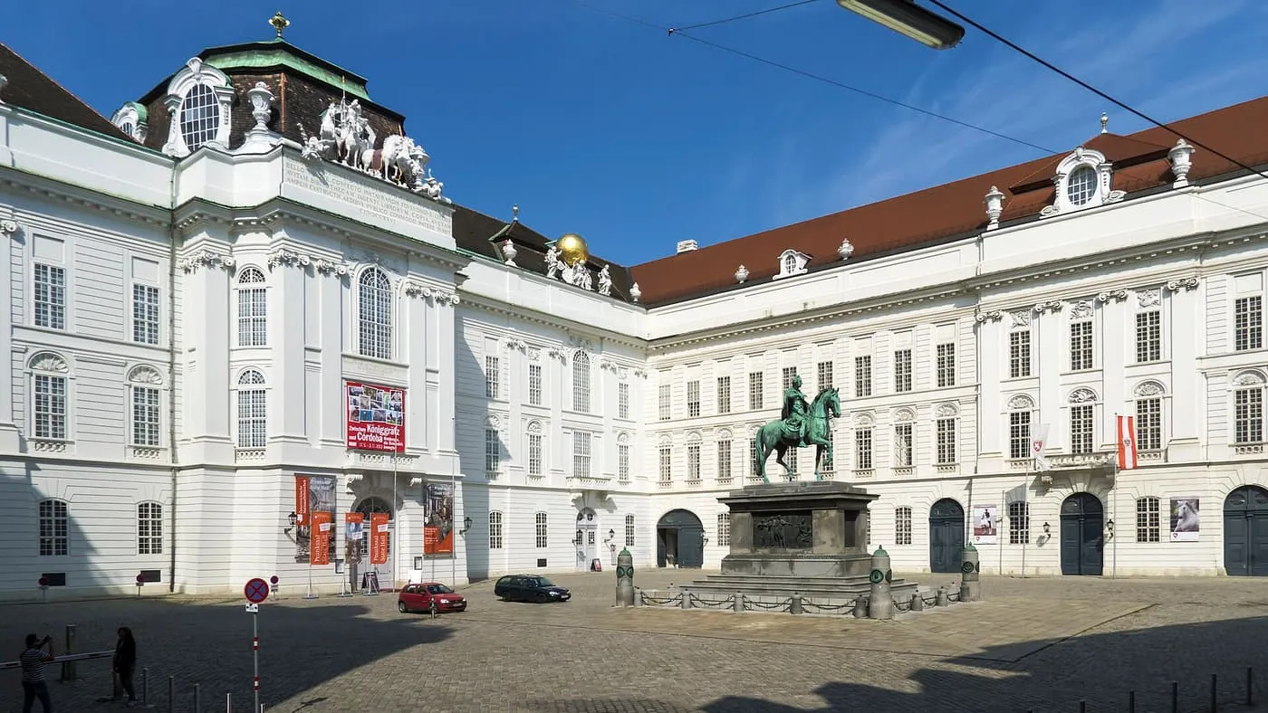 Josefsplatz, a cobbled square with a bronze equestrian statue of Joseph II in front of white Hofburg façades