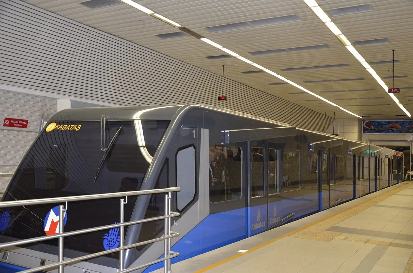 The blue and grey F1 funicular car, marked Kabataş, waiting at its platform in the Taksim station