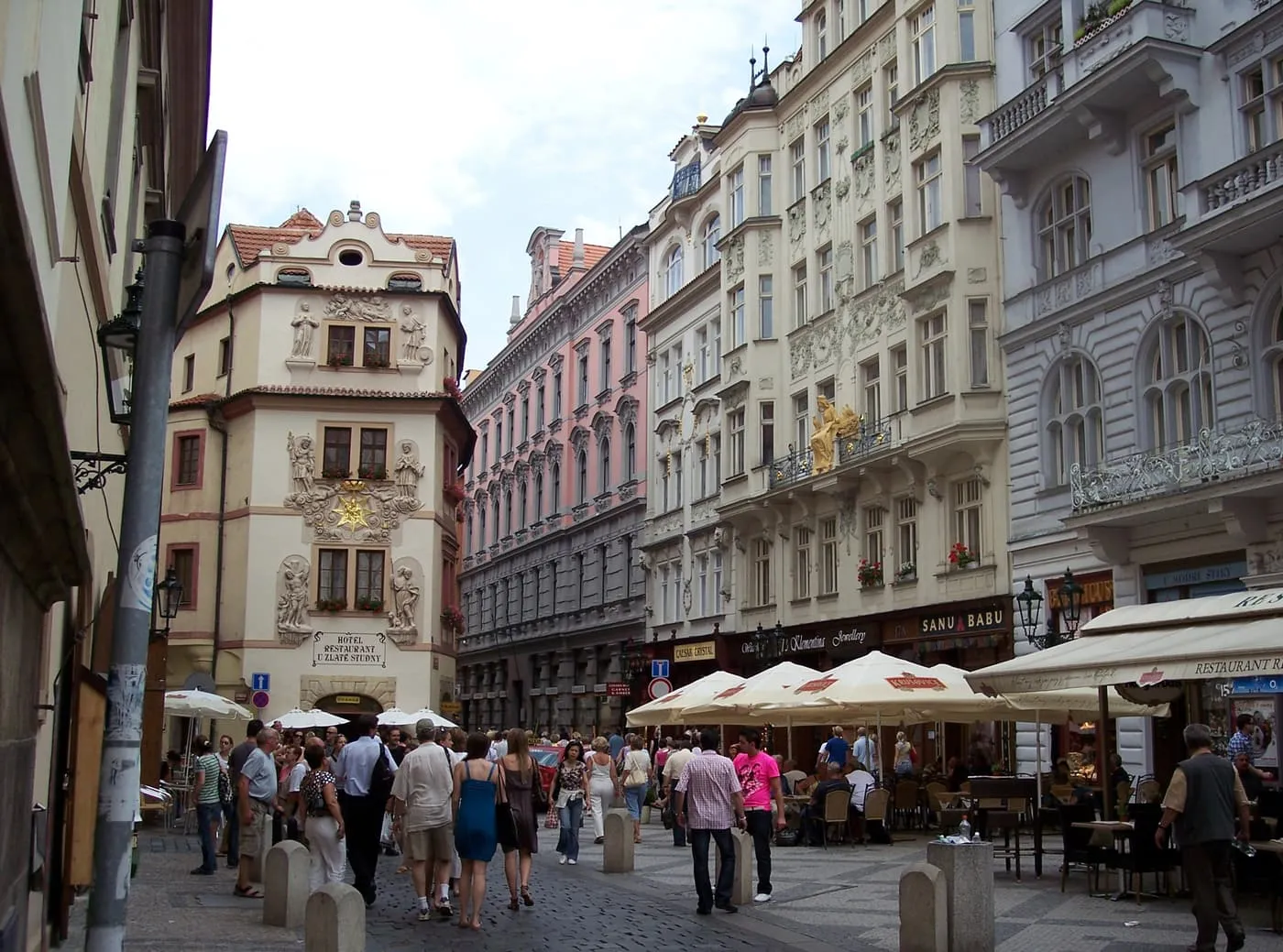 Pedestrians and café terraces in the narrow Karlova street in the Old Town, between ornate town houses