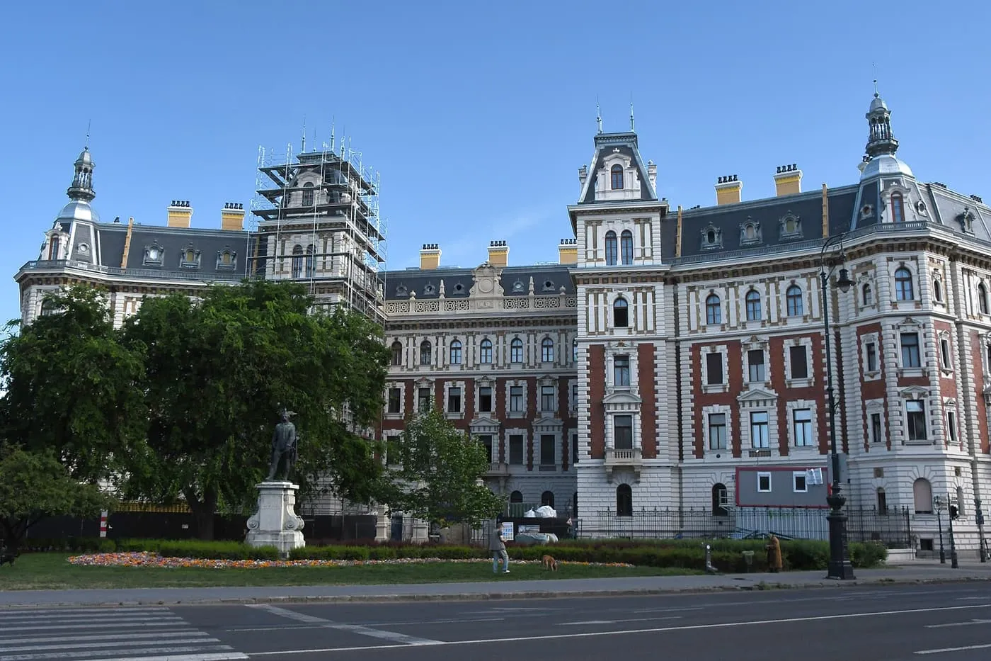 The tall brick and stone Neo-Renaissance buildings round Kodály körönd, with a statue in the circular park in front