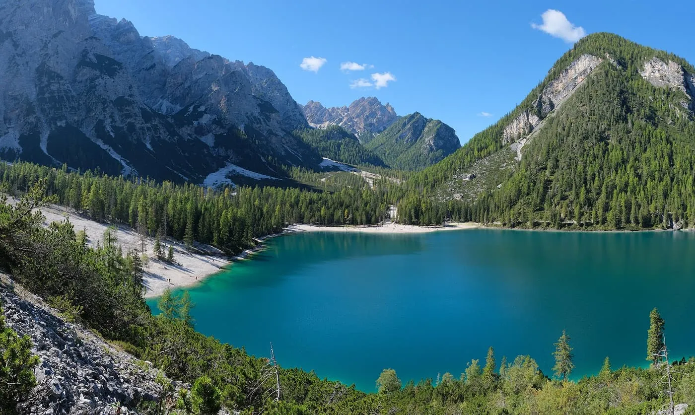 Turquoise Lake Braies ringed by forest and rocky Dolomite peaks