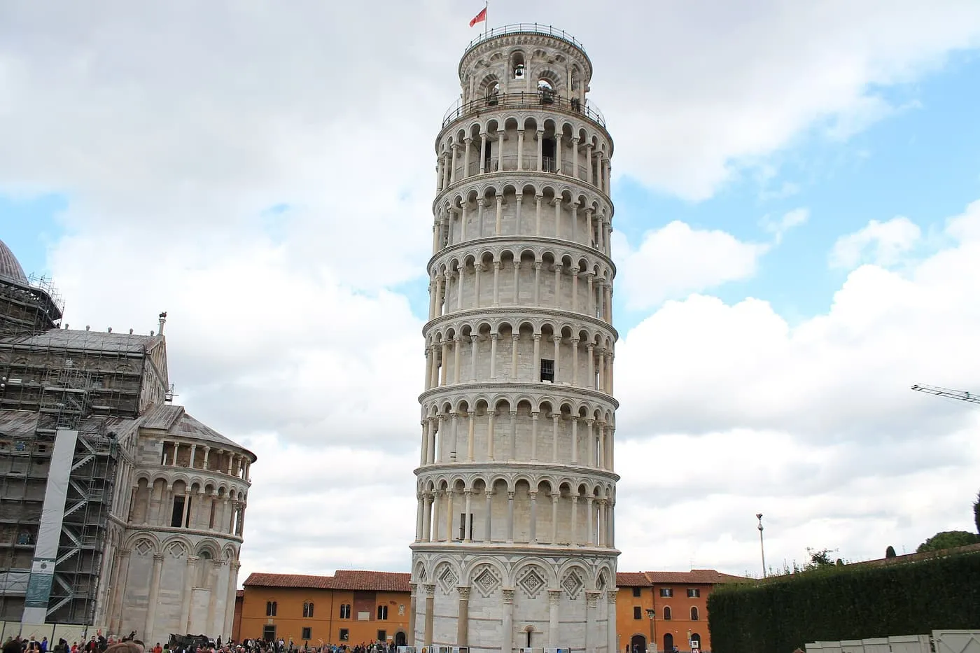 The Leaning Tower of Pisa rising above the square, with the end of the Cathedral at left