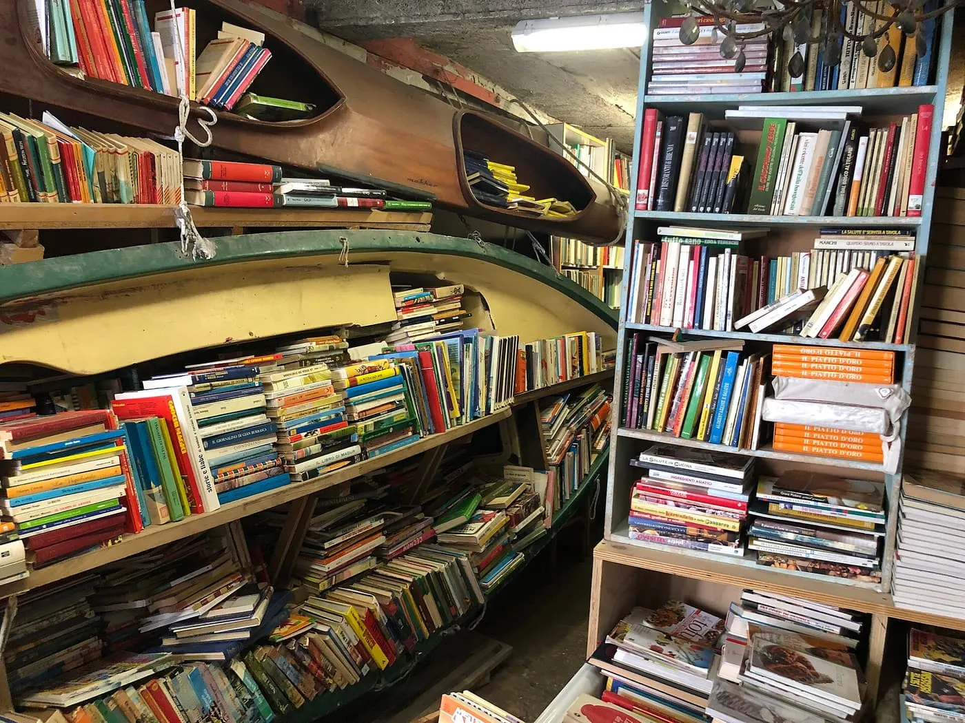 Shelves of books packed into a gondola at the Libreria Acqua Alta