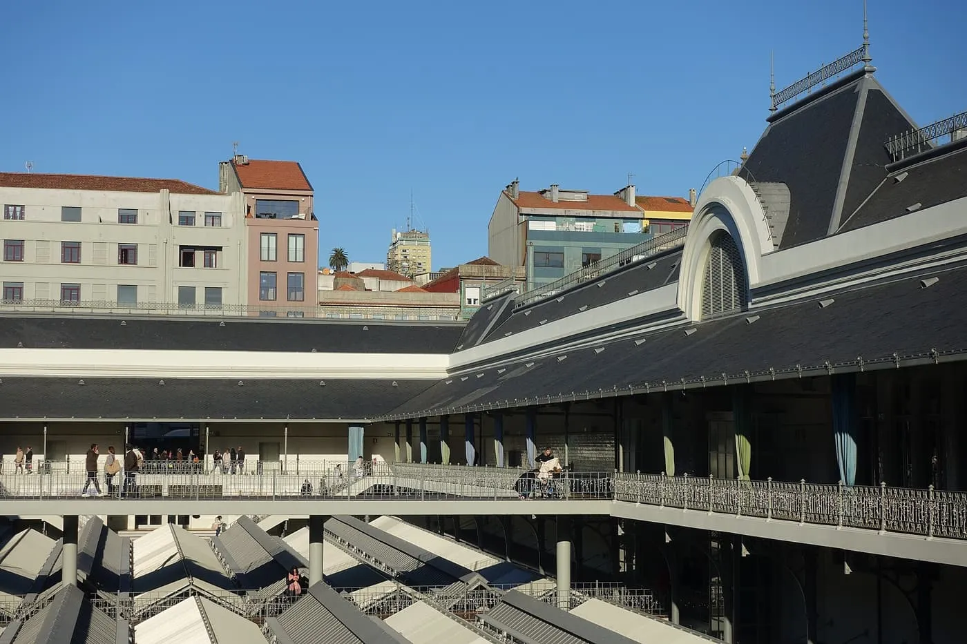 The rebuilt Mercado do Bolhão seen from an upper gallery, with the stall roofs below and the slate-roofed hall behind