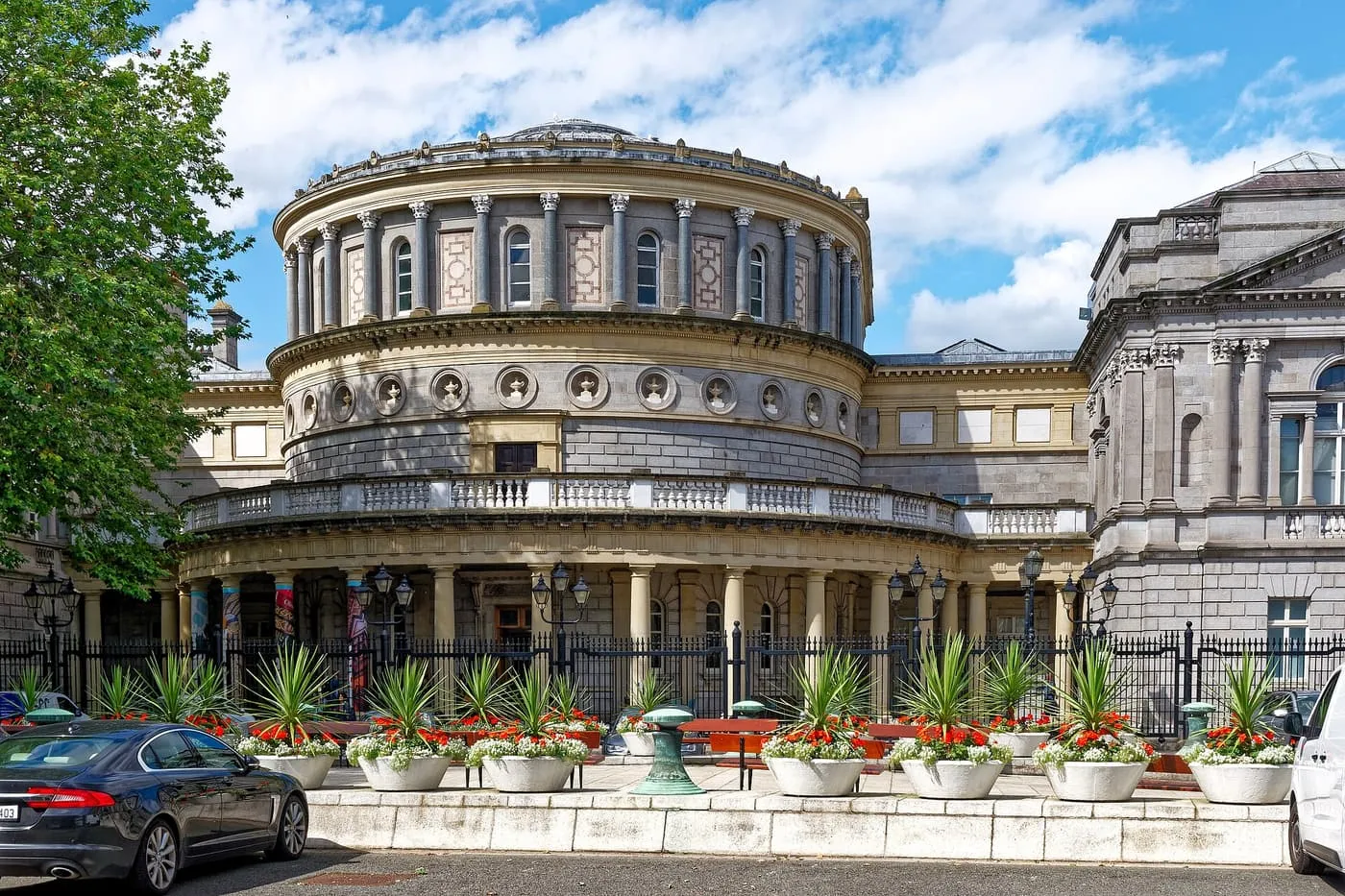 The round colonnaded rotunda of the National Museum of Ireland on Kildare Street, with planters along the railings in front