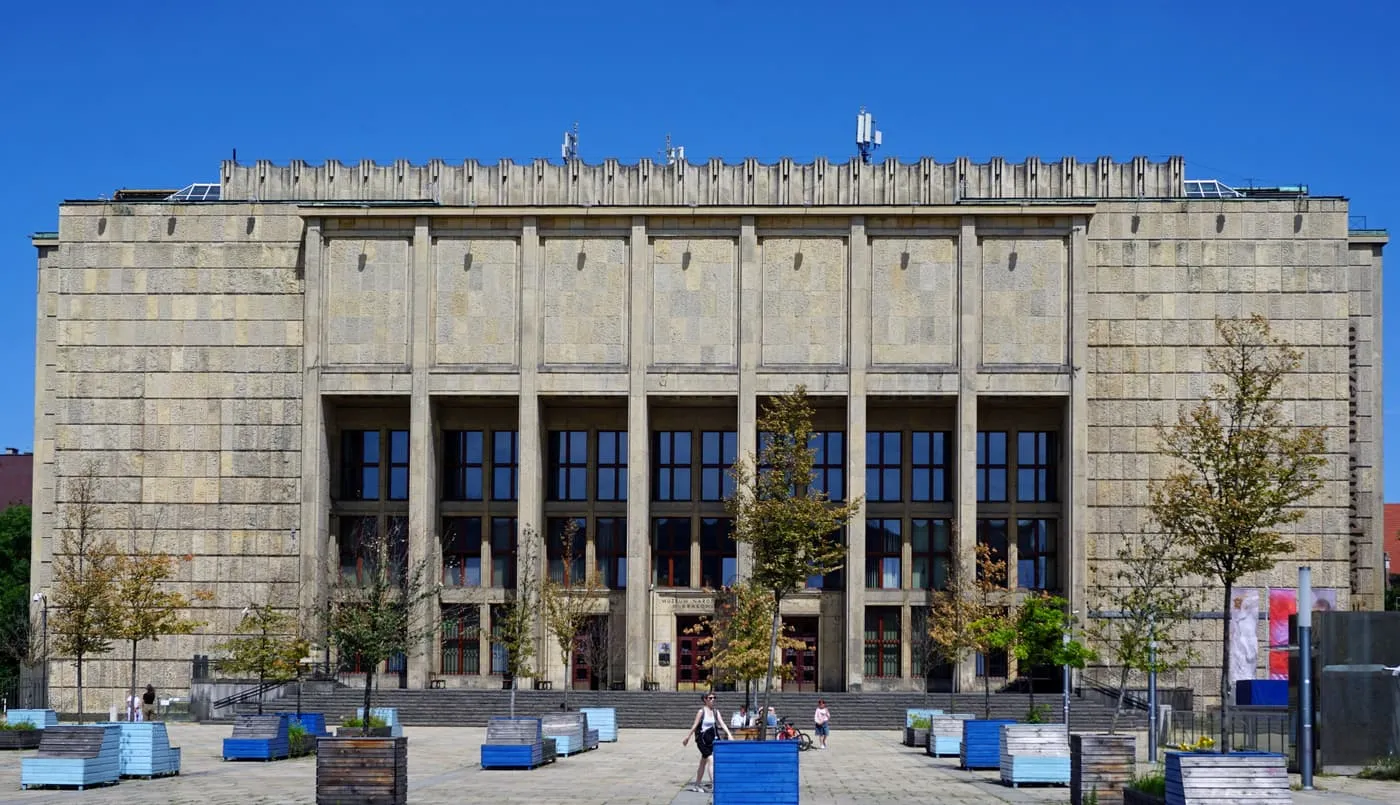 The front of the National Museum Main Building, a stone block with a colonnade and planters on the forecourt