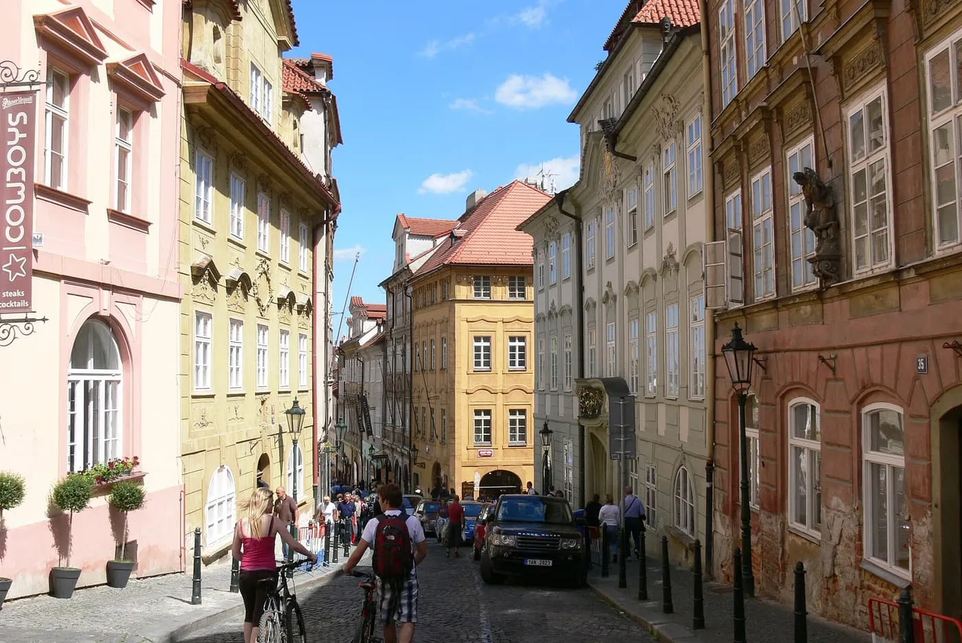 Nerudova Street, a steep cobbled street of narrow pastel-coloured Baroque houses, with a few walkers